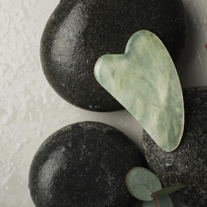Close-up of a Gua Sha stone, highlighting its smooth surface and contours, essential for sculpting and rejuvenating skin during SolRae Wellness Spa's Gua Sha sculpting facial.